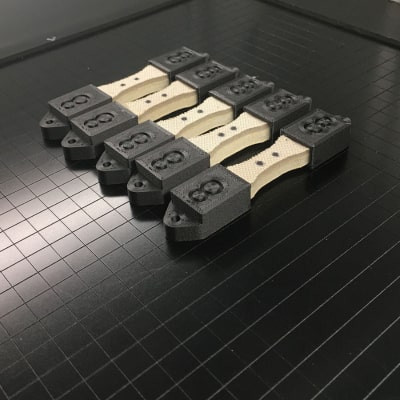 Foam tensile test specimens glued into 3D printed holders.