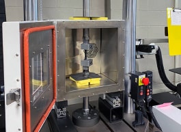 Plastic fatigue instrument with environmental chamber.